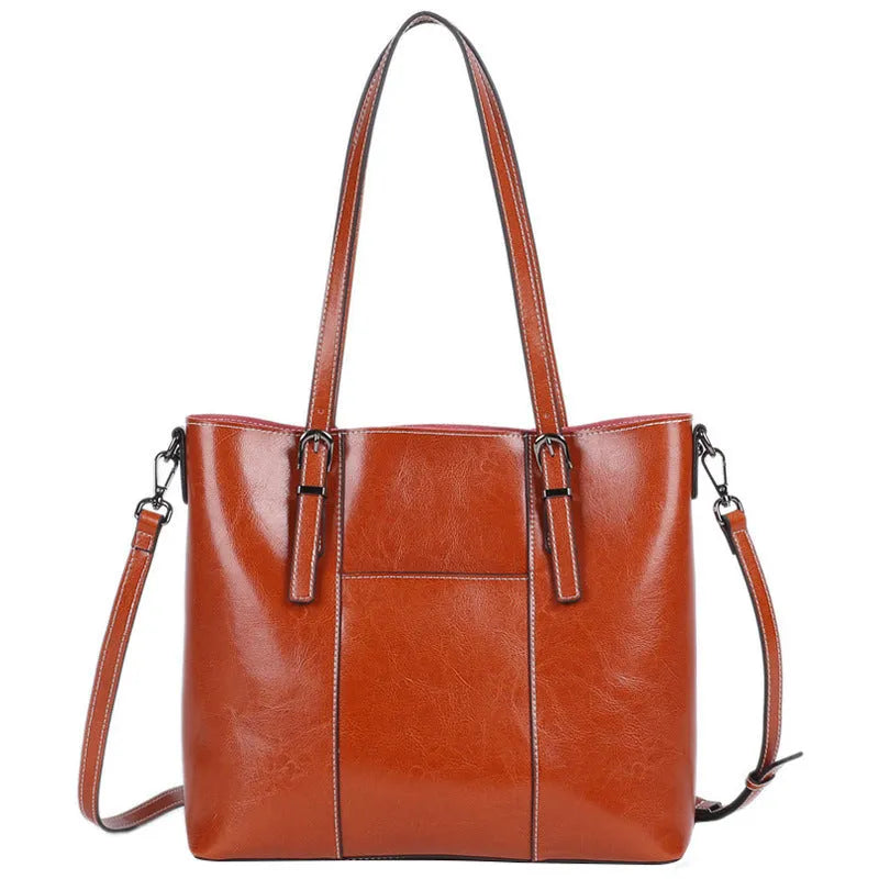 Brown genuine leather women's retro shoulder bag showing front view and organised interior pockets.
