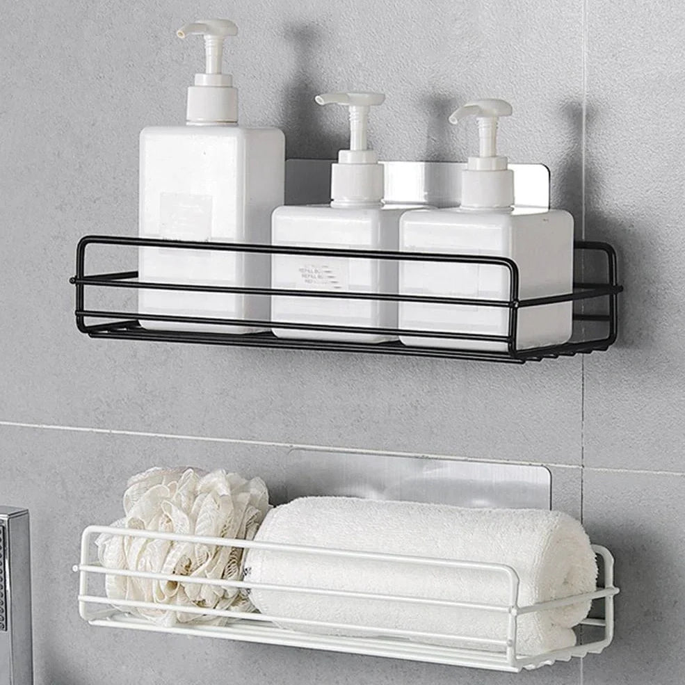 Black wrought iron bathroom shelf, 60cm long with drainage holes, holding shampoo bottles over tub edge