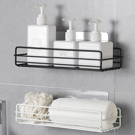 Black wrought iron bathroom shelf, 60cm long with drainage holes, holding shampoo bottles over tub edge