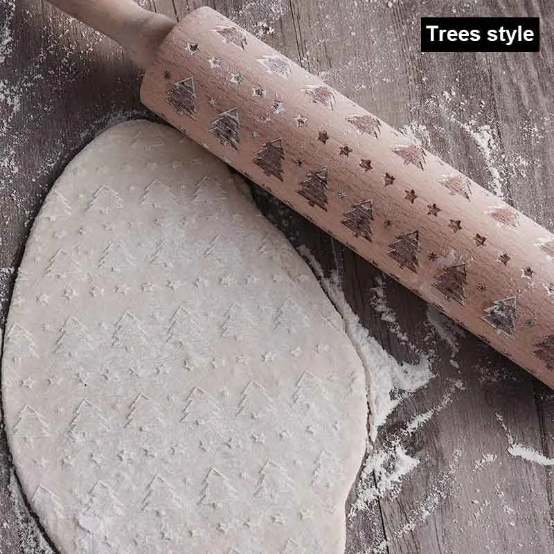 Wooden rolling pin with engraved Christmas patterns including reindeer and snowflakes on a 45cm long barrel.