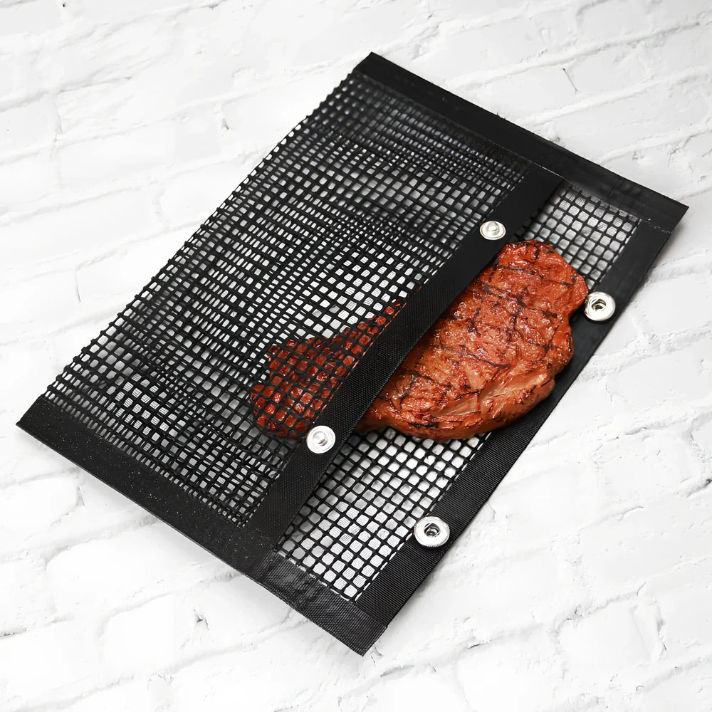 Black grill mesh bag with non-stick grid mat on barbecue, showing smoke circulation through mesh design