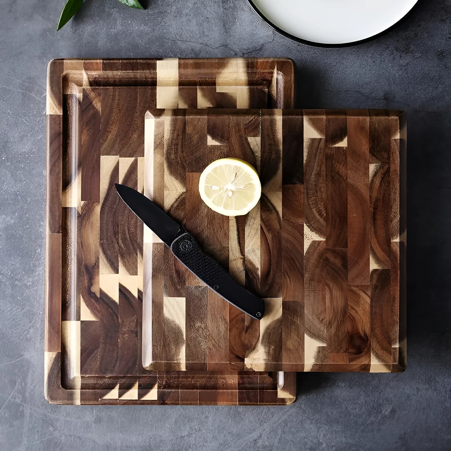 Brown solid acacia wood cutting board with 3cm thick edge, shown in large and small size options.
