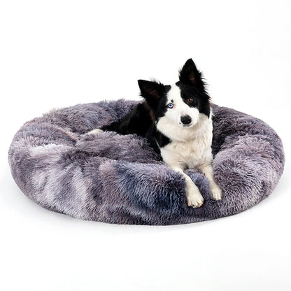 Fluffy donut-shaped dog bed in dark grey colour with raised edges, showing plush texture and circular design