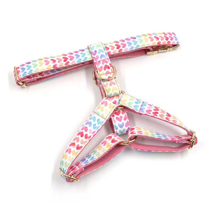 Pink colourful dog harness with heart-shaped stones and gold buckle in chest and back strap design