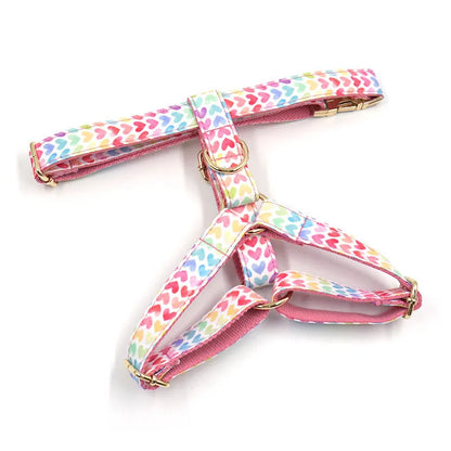 Pink colourful dog harness with heart-shaped stones and gold buckle in chest and back strap design