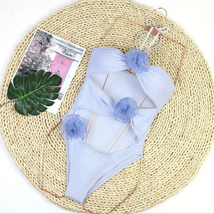 Women's black one-piece swimsuit with 3D flower print and bikini-style design for swimming and sports.