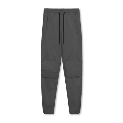 Men's grey fitness trousers with ankle ties, made from quick-drying polyester, for exercise and casual use.