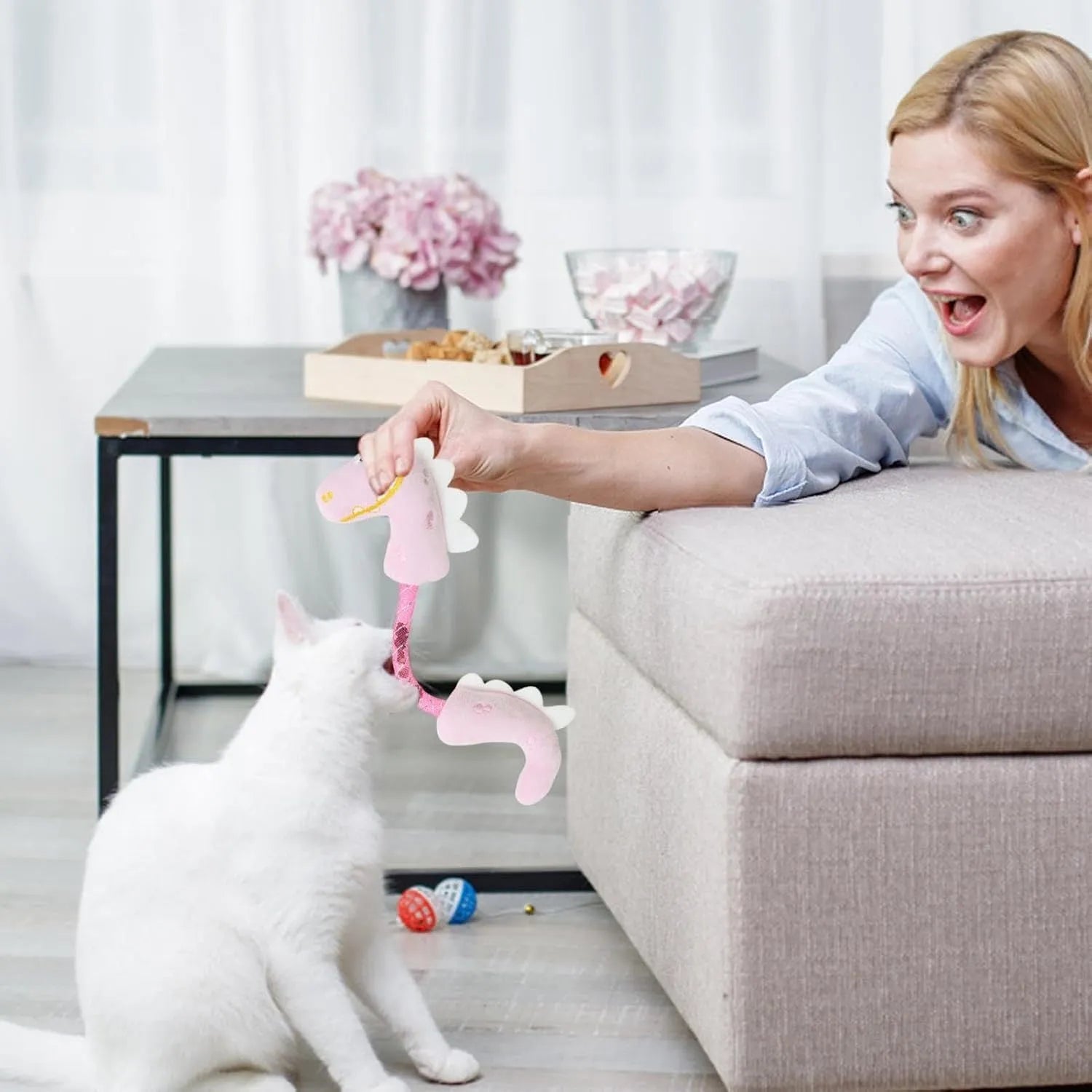 Set of four colourful plush cat toys: a fish, a mouse, a bunny, and a knotted rope, on a neutral background.