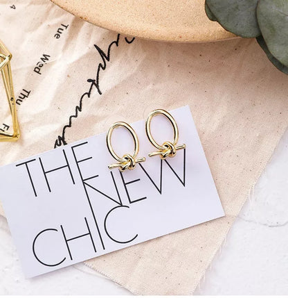 Gold alloy stud earrings with oval knotted design