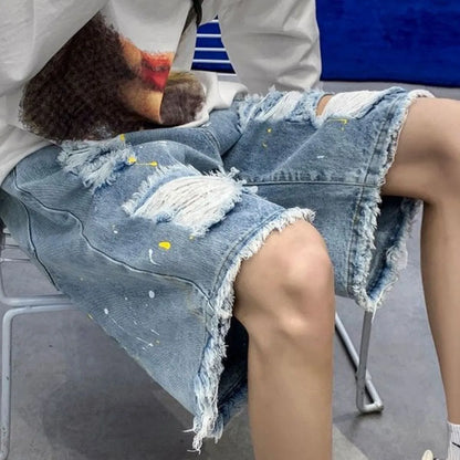 Man wearing loose-fit light blue water-washed denim shorts, street style, fifth-pant length, for summer.