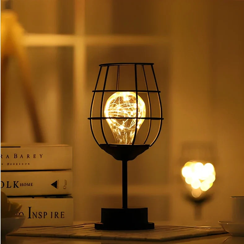 Minimalist hollow table lamp in red wine bottle design with wrought iron construction and warm white LED illumination