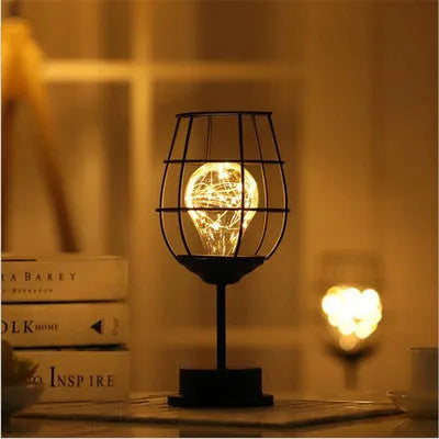 Minimalist hollow iron table lamp with warm white LED light in red wine glass design