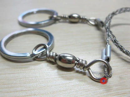 Outdoor survival wire saw with stainless steel blade and pull ring handles for camping and bushcraft