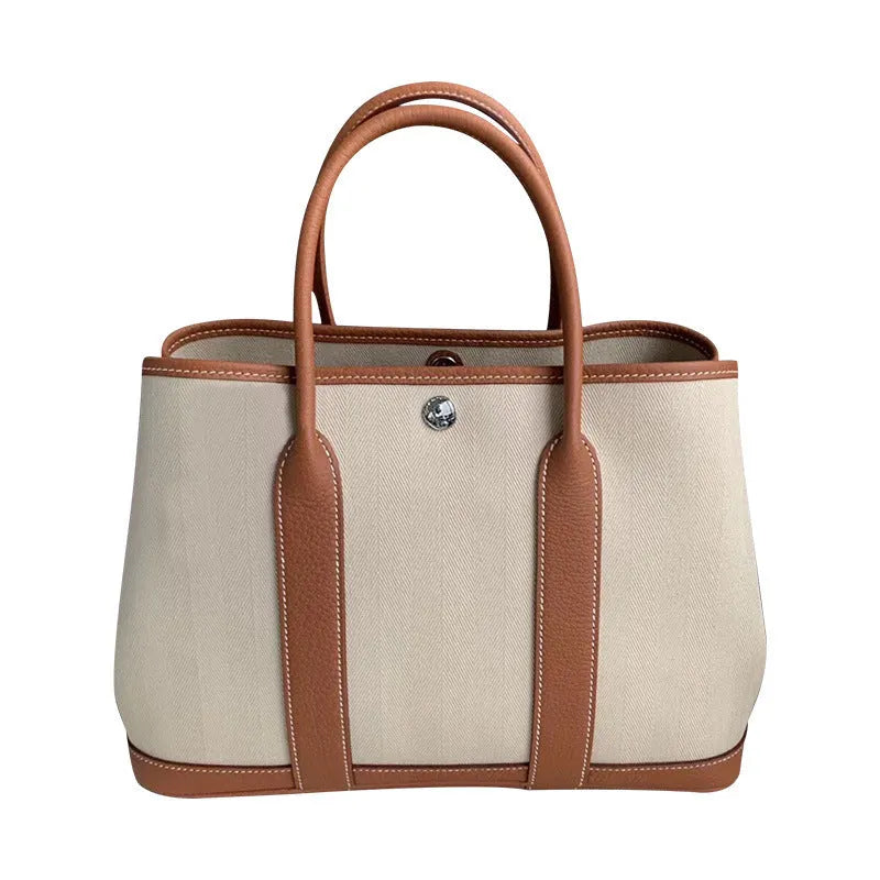 Women's bag genuine leather canvas crossbody tote bucket bag versatile shoulder bag portable shopping bag, available in 25cm and 30cm sizes with colours including black, brown, grey, and red and internal zipper compartments.