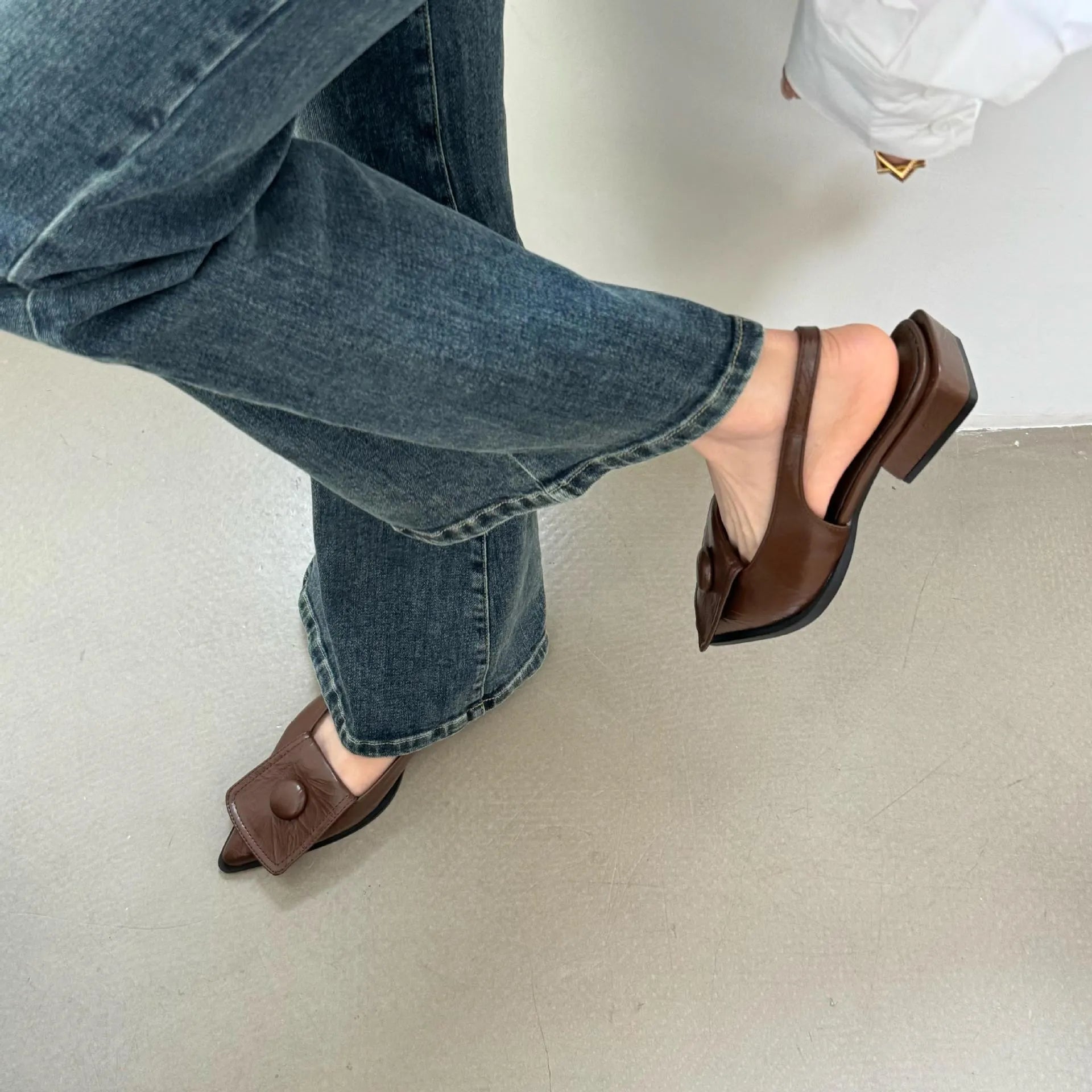 Women's low-heel pointed toe sandals with a back strap in black, brown, apricot, and silver colours.