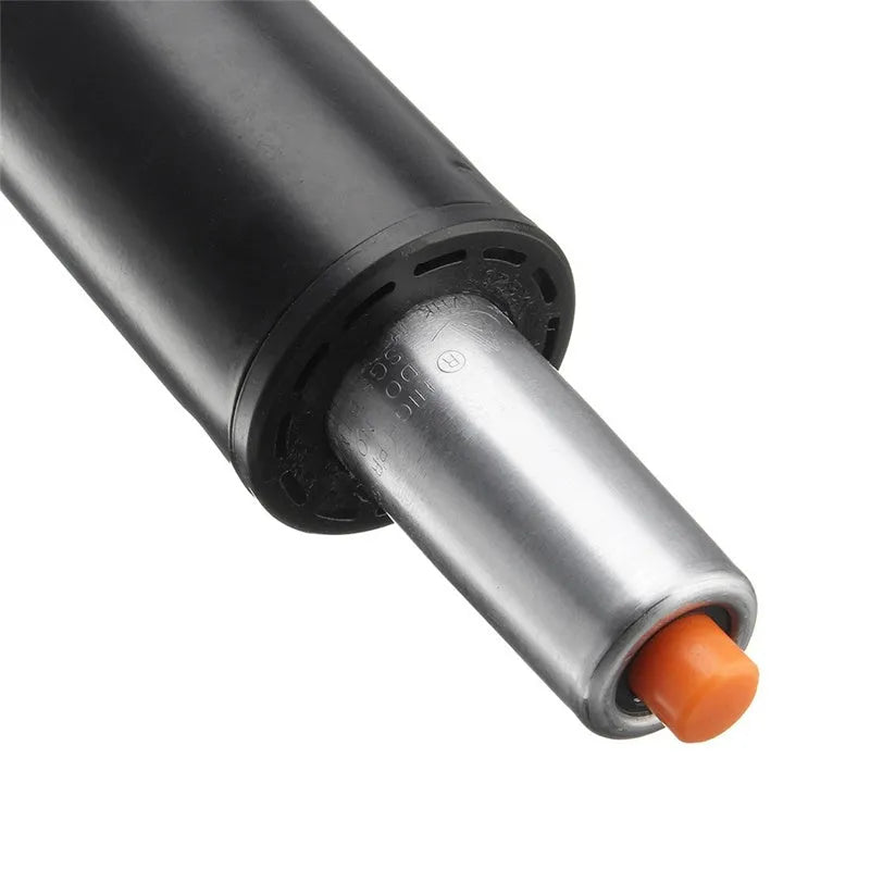 Gas spring for manual lift chair assembly in black paint and silver electroplated finishes.