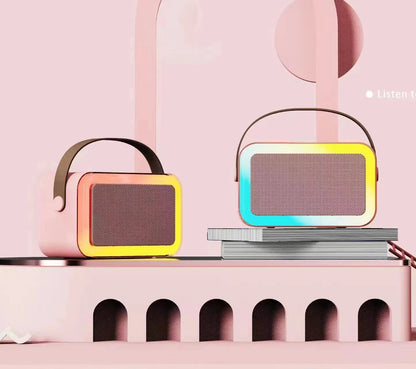 Portable Bluetooth karaoke microphone speaker with coloured LED lights in pink colour option showing microphone input and control buttons