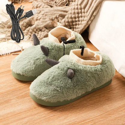USB heated slippers in grey with a USB cable plugged into a power bank, showing the enclosed velvet design.