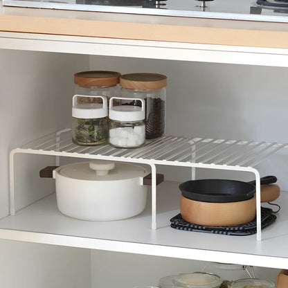 White retractable kitchen shelf extended to 60cm with spices and oils organised on metal surface