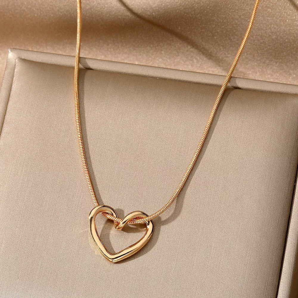 Niche Hollow Heart Necklace for women with snake bones chain and electroplated alloy