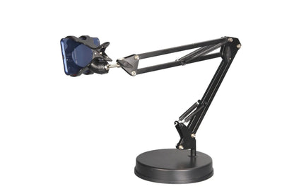 Black universal phone stand with long metal arm and heavy round base on a wooden desk