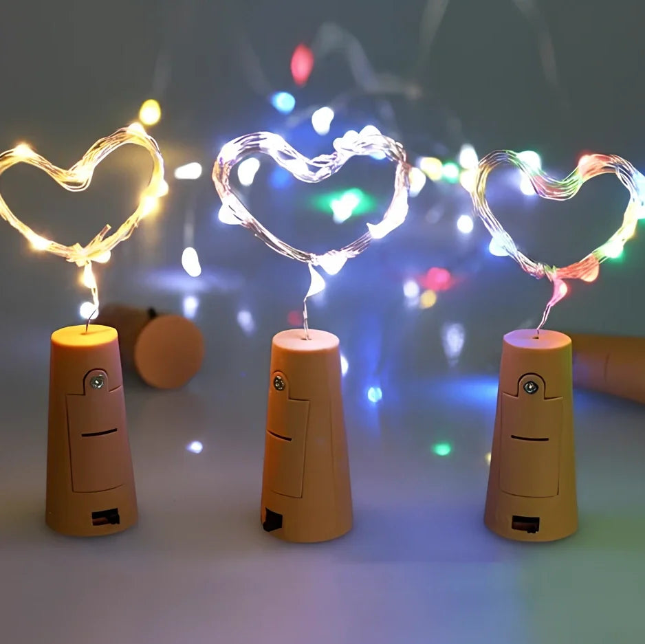 Copper wire LED string lights wrapped around wine bottle with 20 white LEDs illuminated
