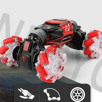 Red 4WD RC stunt car performing sideways drift with LED lights illuminated, showing gesture remote control