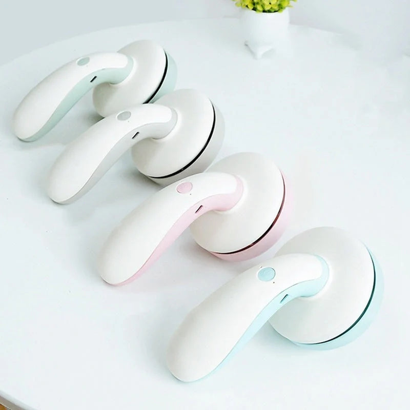 Mini desktop vacuum cleaner in pink, green, blue, and gray for dust removal