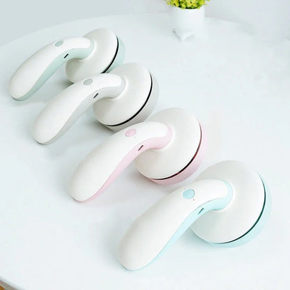 Mini desktop vacuum cleaner in pink, green, blue, and gray for dust removal