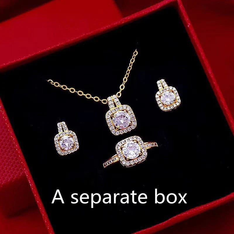 Elegant gold-toned jewelry set including necklace, earrings, and ring with zircon gemstone pendant