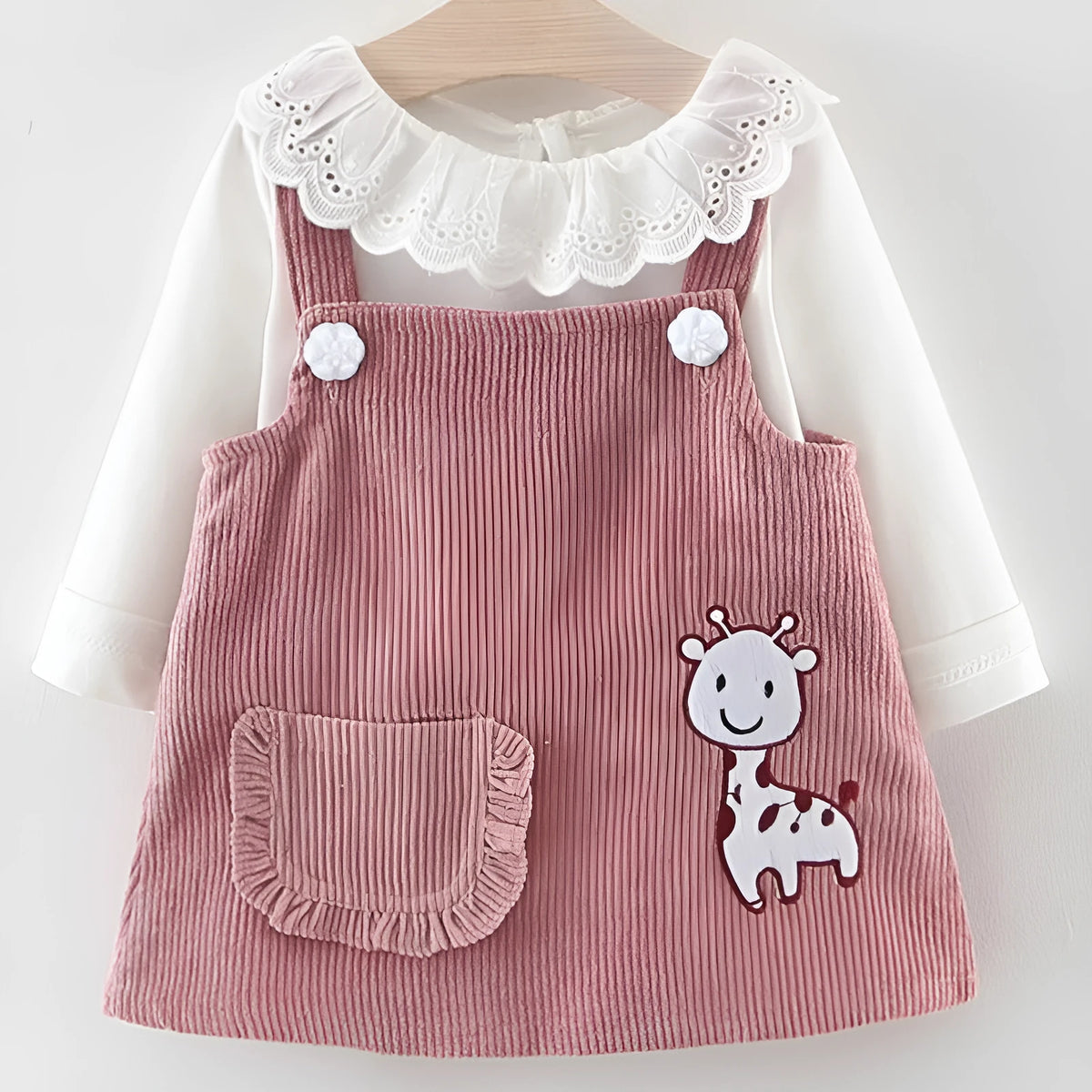 Baby girl two-piece cotton dress set with long-sleeve top and suspender skirt in yellow or pink.