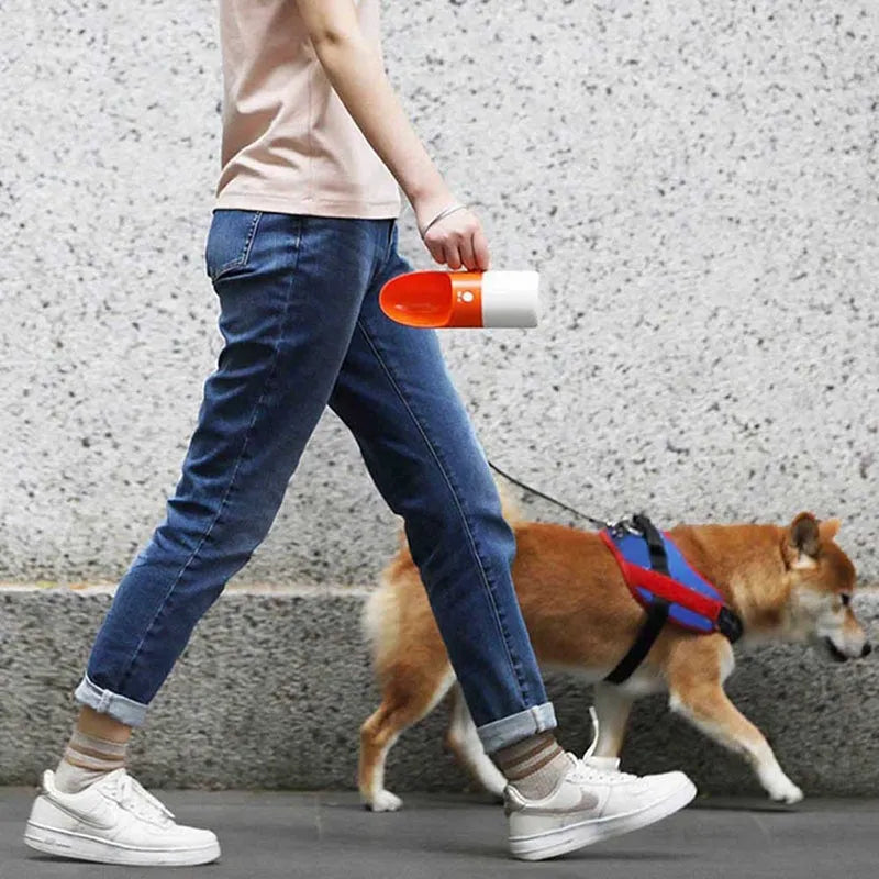 White and grey rocket-shaped pet water bottle with drinking outlet and lock button
