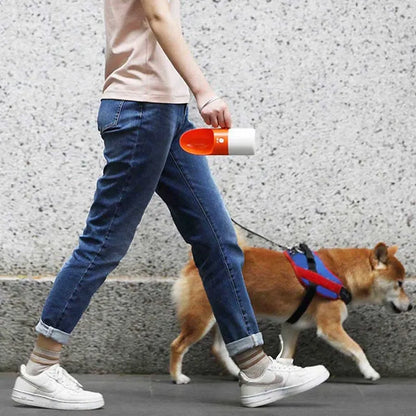 White and grey rocket-shaped pet water bottle with drinking outlet and lock button