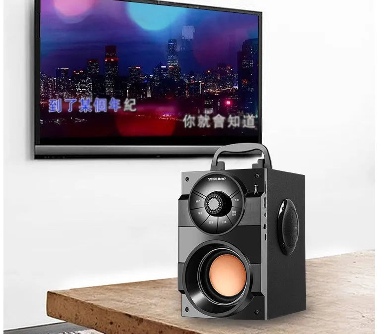 Black portable mini home audio system with built-in subwoofer, 3.5mm audio port, and USB charging cable