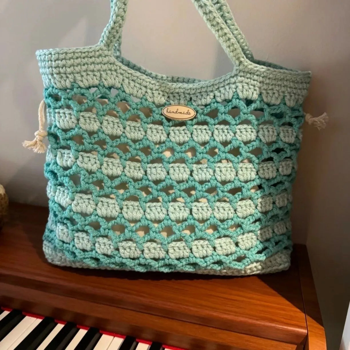 Handmade woven wool bag with floral pattern, approximately 0.5m tall