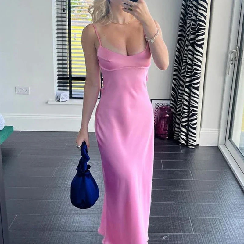 Elegant satin slip dress in pink with a flattering, form-fitting silhouette and sexy backless design