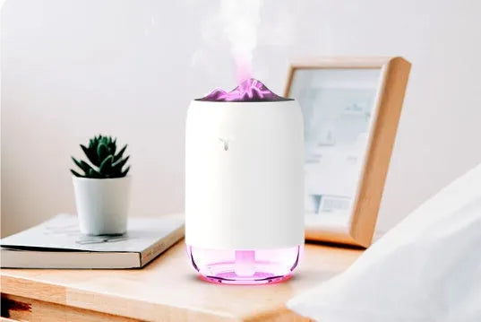 Compact cylindrical USB humidifier with night light in white, pink, or green, showing mist output.