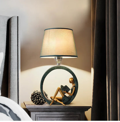 Blue reading night light with resin base and cloth shade measuring 20x39.8cm