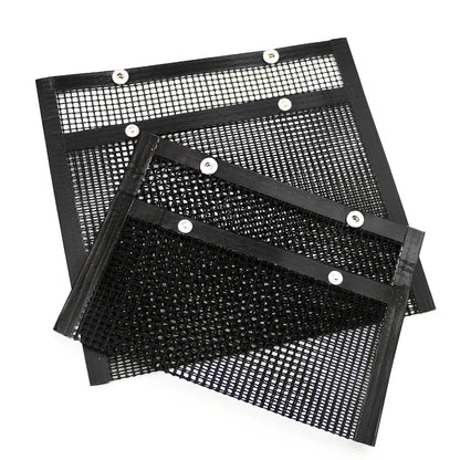 Black grill mesh bag with non-stick grid mat on barbecue, showing smoke circulation through mesh design
