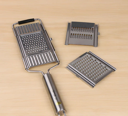 Green mandolin chopper with hand guard, food container, and three blades for safe vegetable slicing