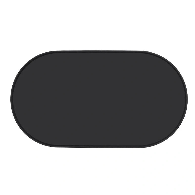 Green silicone cat feeding placemat with raised edges on wooden floor containing water bowl