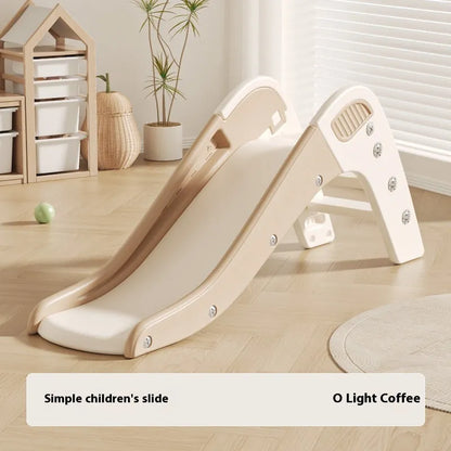 Small blue plastic baby slide for toddlers in a garden setting.