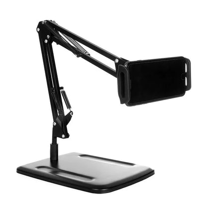 Black universal phone stand with long metal arm and heavy round base on a wooden desk