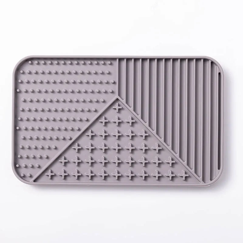 Silicone pet licking mat with suction cup base in pink, grey, or khaki colour options for slow feeding dogs and cats.