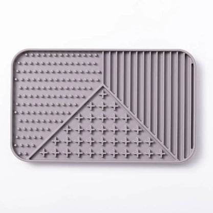 Silicone pet licking mat with suction cup base in pink, grey, or khaki colour options for slow feeding dogs and cats.