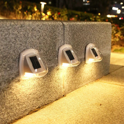 Solar garden wall lamp with waterproof housing mounted on brick wall