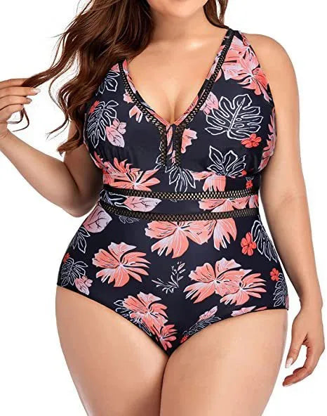 Black plus-size bikini swimsuit with print design and mesh fabric, shown on a hanger.