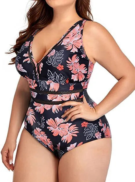 Black plus-size bikini swimsuit with print design and mesh fabric, shown on a hanger.