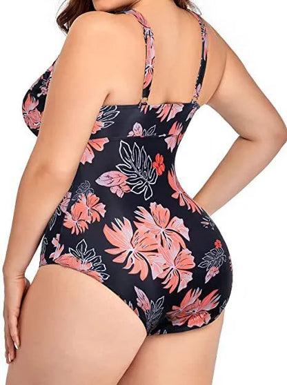 Black plus-size bikini swimsuit with print design and mesh fabric, shown on a hanger.