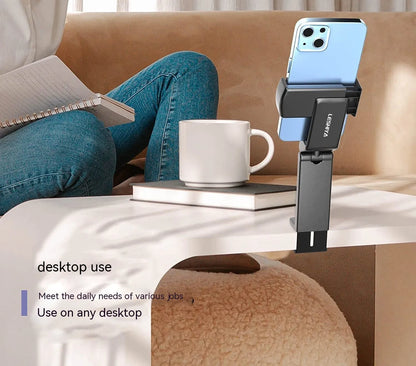 Black foldable rotating phone holder stand on a desk, showing universal phone compatibility and adjustable angles